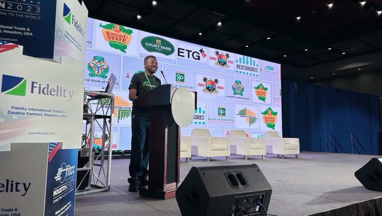 Femi Royal speaking on stage at a conference