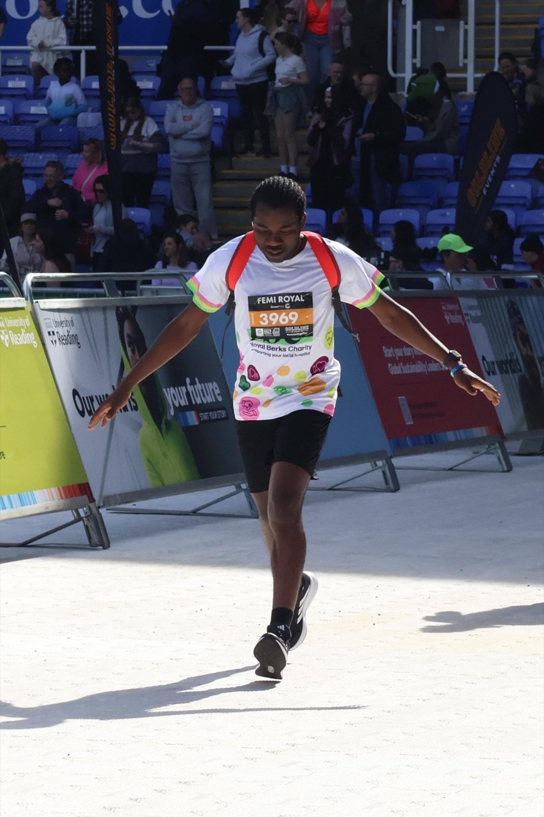 Femi Royal crossing a half marathon finish line